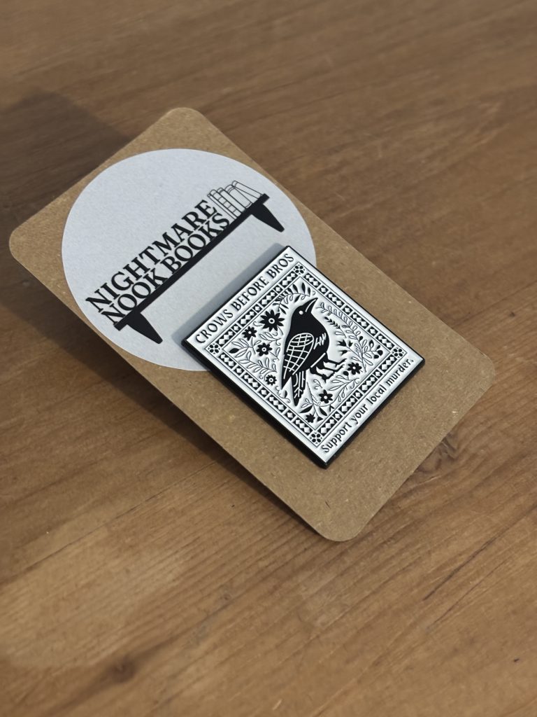 Crows before Bros gothic enamel pin on backing card
