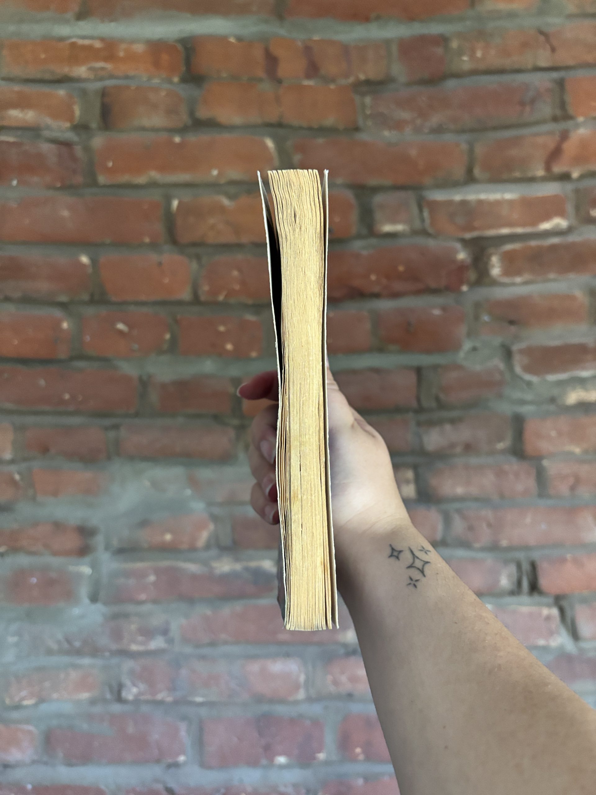Angled view of R.L. Stine’s The Hitchhiker paperback showing book edge